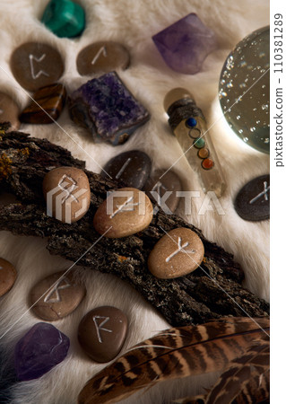 handmade stone runes on white fur handmade stone runes on white fur 110381289
