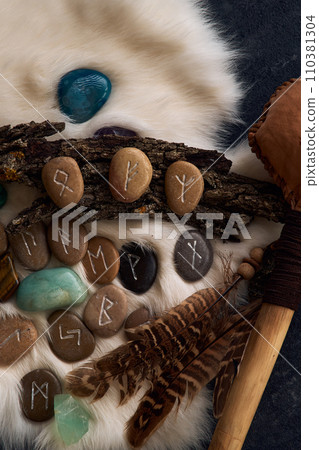 handmade stone runes on white fur 110381304