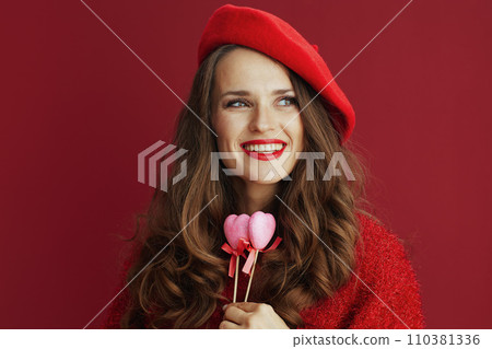 happy modern woman in red sweater and beret 110381336
