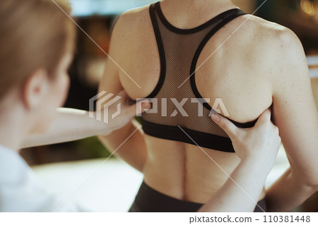 Massage therapist checking clients back condition 110381448