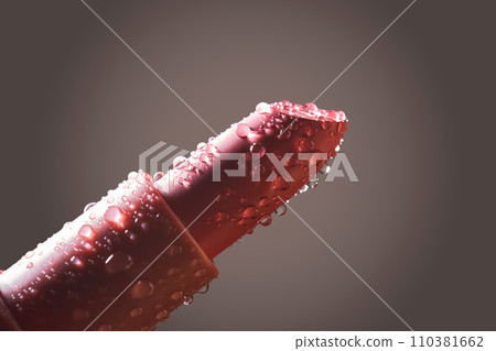 Red lipstick with water drops on a dark background. Red lipstick with water drops on a dark background. 110381662