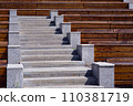 wooden benches along the granite stairs going up to the street theater on a sunny summer day, nobody. 110381719