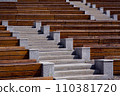 granite stairs between empty wooden benches at street theater on a sunny summer day, nobody. 110381720