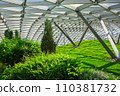 glass roof indoor safety park with green hill and different bushes lit by sunlight, nobody. 110381732