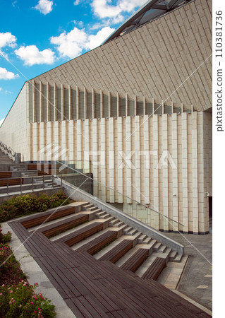 an open-air theater, benches in the form of a staircase at the front of the building, an urban seating area. an open-air theater, benches in the form of a staircase at the front of the building, an urban seating area. 110381736