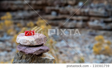 Red dice on a tower of stones. Concept of chance and victory. 110381739