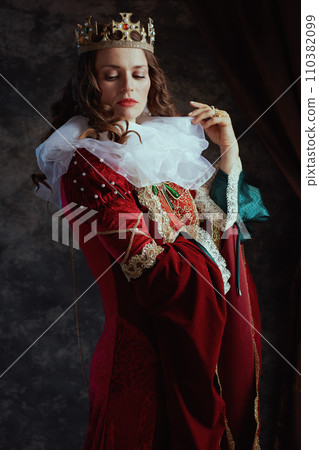 medieval queen in red dress with white collar and crown medieval queen in red dress with white collar and crown 110382099
