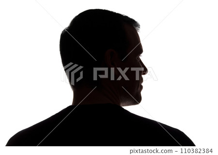 Portrait of a young man, back view - dark isolated silhouette Portrait of a young man, back view - dark isolated silhouette 110382384