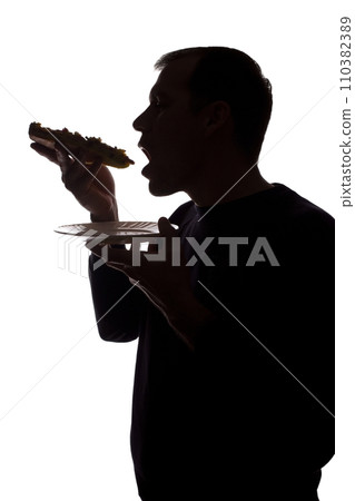 Portrait of a young man eat pizza, side view - silhouette 110382389