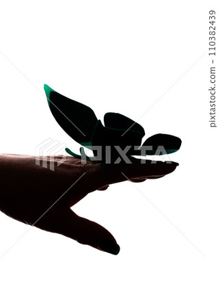 Female hand with artificial butterfly, butterfly layout - silhouette isolated 110382439
