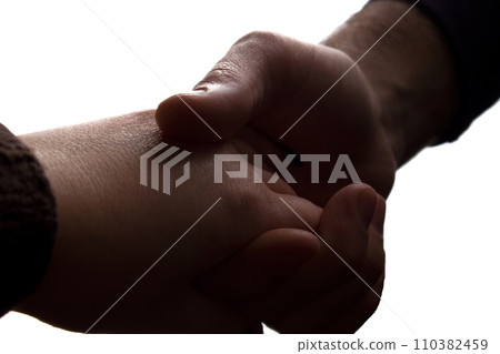 Man gently holding his beloved by the hand - silhouette love 110382459