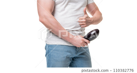 Man crop view giving thumb holding eggplant at crotch level imitating erect penis isolated on white Man crop view giving thumb holding eggplant at crotch level imitating erect penis isolated on white 110382776
