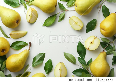 Frame of ripe yellow pears with leaves and fruit halves 110383368