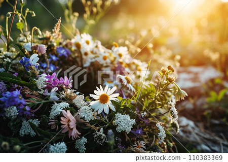 Wild flowers wreath in morning meadow in sunrise Wild flowers wreath in morning meadow in sunrise 110383369