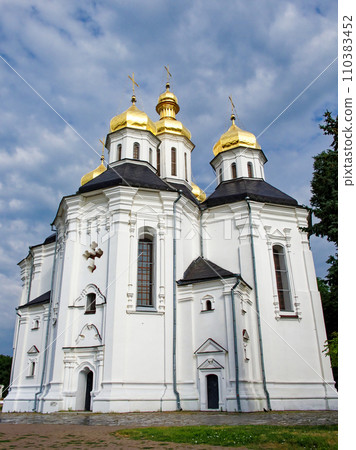 In this picturesque moment, Catherine's Church, a splendid example of Ukrainian Baroque architecture, graces the landscape with its iconic white facade and five radiant golden domes. 110383452