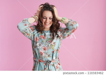 cheerful elegant 40 years old woman in floral dress on pink cheerful elegant 40 years old woman in floral dress on pink 110383462