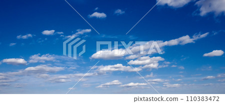 A peaceful blue sky with white clouds. A peaceful blue sky with white clouds. 110383472