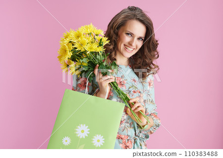 smiling elegant 40 years old woman in floral dress on pink smiling elegant 40 years old woman in floral dress on pink 110383488