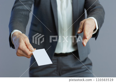 Stylish business woman giving hand for handshake against grey Stylish business woman giving hand for handshake against grey 110383519