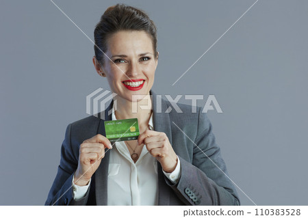 happy elegant business woman against gray background happy elegant business woman against gray background 110383528