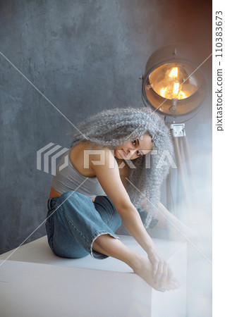 Female model with grey lush hair posing in studio Female model with grey lush hair posing in studio 110383673