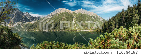 Tatra National Park, Poland. Panorama Famous Mountains Lake Morskie Oko Or Sea Eye Lake In Summer Morning. Five Lakes Valley. Beautiful Scenic View. European Nature Tatra National Park, Poland. Panorama Famous Mountains Lake Morskie Oko Or Sea Eye Lake In Summer Morning. Five Lakes Valley. Beautiful Scenic View. European Nature 110384168