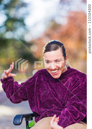 Hispanic Woman with cerebral palsy disability diversity, Portrait waving and greeting to camera 110384800