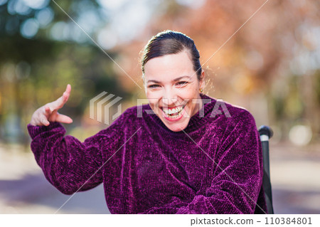 Hispanic Woman with cerebral palsy disability diversity, Portrait waving and greeting to camera Hispanic Woman with cerebral palsy disability diversity, Portrait waving and greeting to camera 110384801