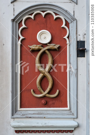 Old medicine symbol of old pharmacy. Retro emblem of medicine - two snakes, caduceus, signboard on a wooden door. Old medicine symbol of old pharmacy. Retro emblem of medicine - two snakes, caduceus, signboard on a wooden door. 110385008