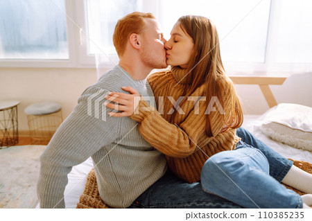 Couple in love relaxing at home on bed while they hug each other. Valentine's Day, holiday concept. Couple in love relaxing at home on bed while they hug each other. Valentine's Day, holiday concept. 110385235