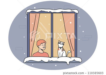 Smiling boy and cat in window during winter Smiling boy and cat in window during winter 110385603