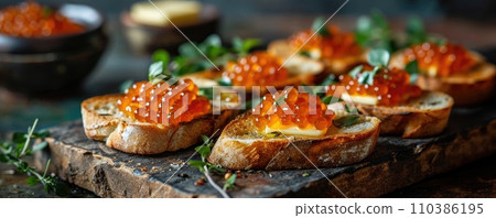 Sandwich with red caviar on a wooden table: a treat for connoisseurs of taste Sandwich with red caviar on a wooden table: a treat for connoisseurs of taste 110386195