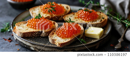 Sandwich with red caviar on a wooden table: a treat for connoisseurs of taste Sandwich with red caviar on a wooden table: a treat for connoisseurs of taste 110386197