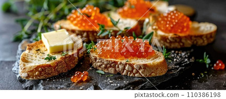 Sandwich with red caviar on a wooden table: a gourmet treat Sandwich with red caviar on a wooden table: a gourmet treat 110386198