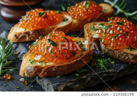 Sandwich with red caviar: a gourmet delicacy on a wooden table Sandwich with red caviar: a gourmet delicacy on a wooden table 110386199