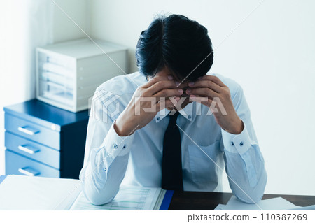 Businessman tired from working long hours Businessman tired from working long hours 110387269