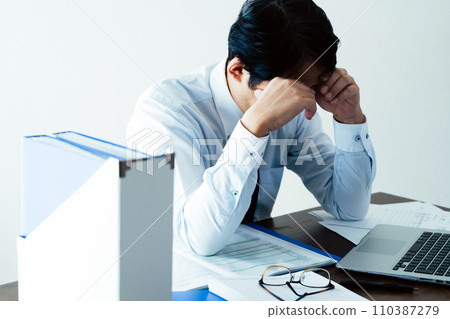 Businessman tired from working long hours Businessman tired from working long hours 110387279
