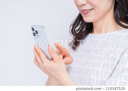 Middle woman (parts) operating a smartphone 110387520