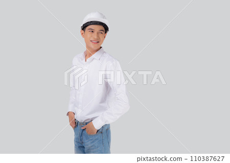 Portrait young asian man is engineer wearing helmet standing and smiling with confident isolated. Portrait young asian man is engineer wearing helmet standing and smiling with confident isolated. 110387627