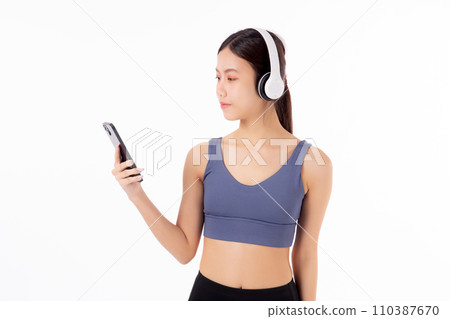 Portrait young asian woman in sportswear wearing headphone listening music with smart phone. 110387670