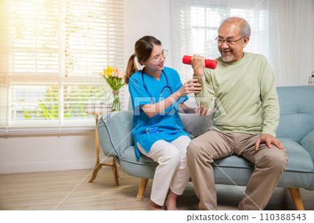Asian nurse physiotherapist helping senior man in lifting dumbell at retirement home, Young nurse take care support training elderly sitting on sofa using dumbbell workout exercise, Healthcare medical 110388543
