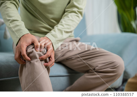 Senior man having painful knee pain after ligament surgery, senior man knee joint pain on sofa at home, Elderly old age pain after falling torn ligament, health problem, Healthcare and medical concept Senior man having painful knee pain after ligament surgery, senior man knee joint pain on sofa at home, Elderly old age pain after falling torn ligament, health problem, Healthcare and medical concept 110388557