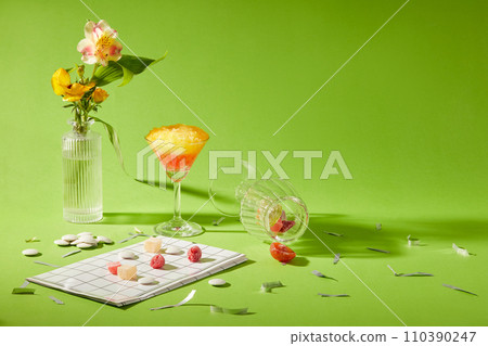 Creative scene for design and advertising product with holiday decoration concept. A cup of smoothie with flowers vase and some snacks decorated on a green background. Front view and copy space 110390247
