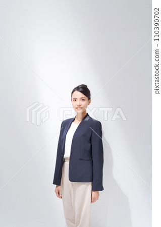 Smiling business woman standing Smiling business woman standing 110390702