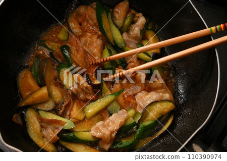 Cooking scene of stir-fried eggplant, cucumber, and pork with spicy miso 110390974