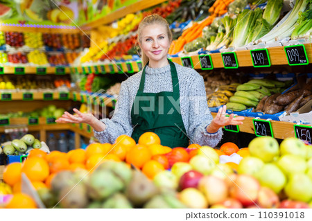 Woman store worker in apron at fruit department of supermarket Woman store worker in apron at fruit department of supermarket 110391018