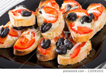 Hot sandwiches with tomatoes and black olives Hot sandwiches with tomatoes and black olives 110391032