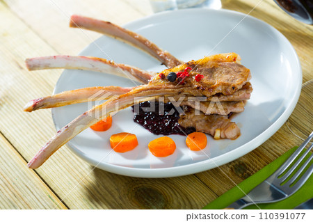 Roasted rack of mutton with berry sauce and carrot Roasted rack of mutton with berry sauce and carrot 110391077