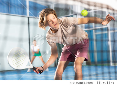 Portrait of a guy tennis player playing padel 110391174