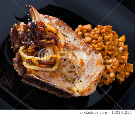 Picture of delicious fried pork with lentils at black plate 110391233